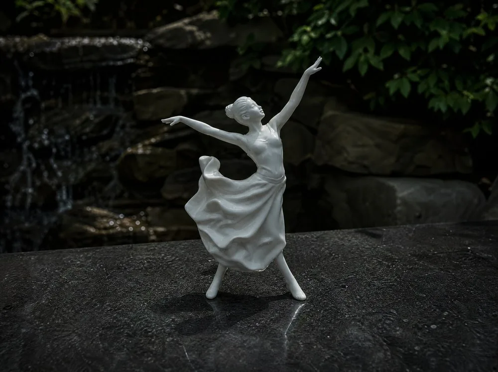 A white porcelain figure on a dark ground